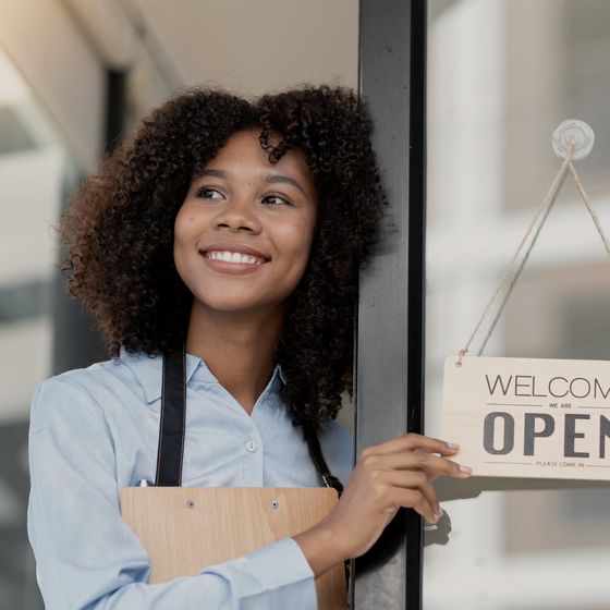A shop owner turning the sign to OPEN